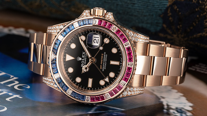 Diamond and Gemstone Watch: Rolex GMT Master II with calibrated cut diamonds, sapphires and rubies
