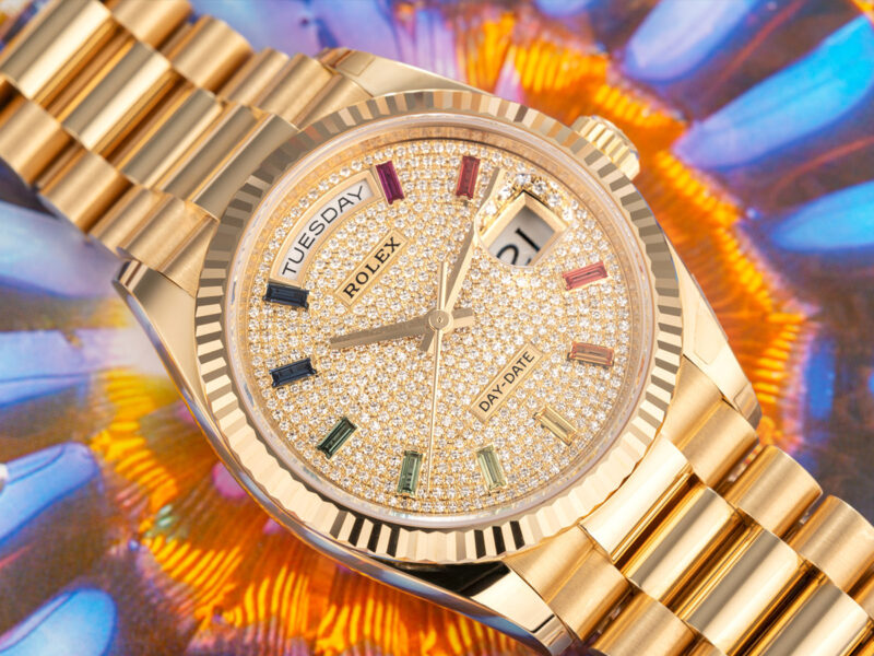 Rolex Day Date Yellow Gold President watch with rainbow dial on colourful background